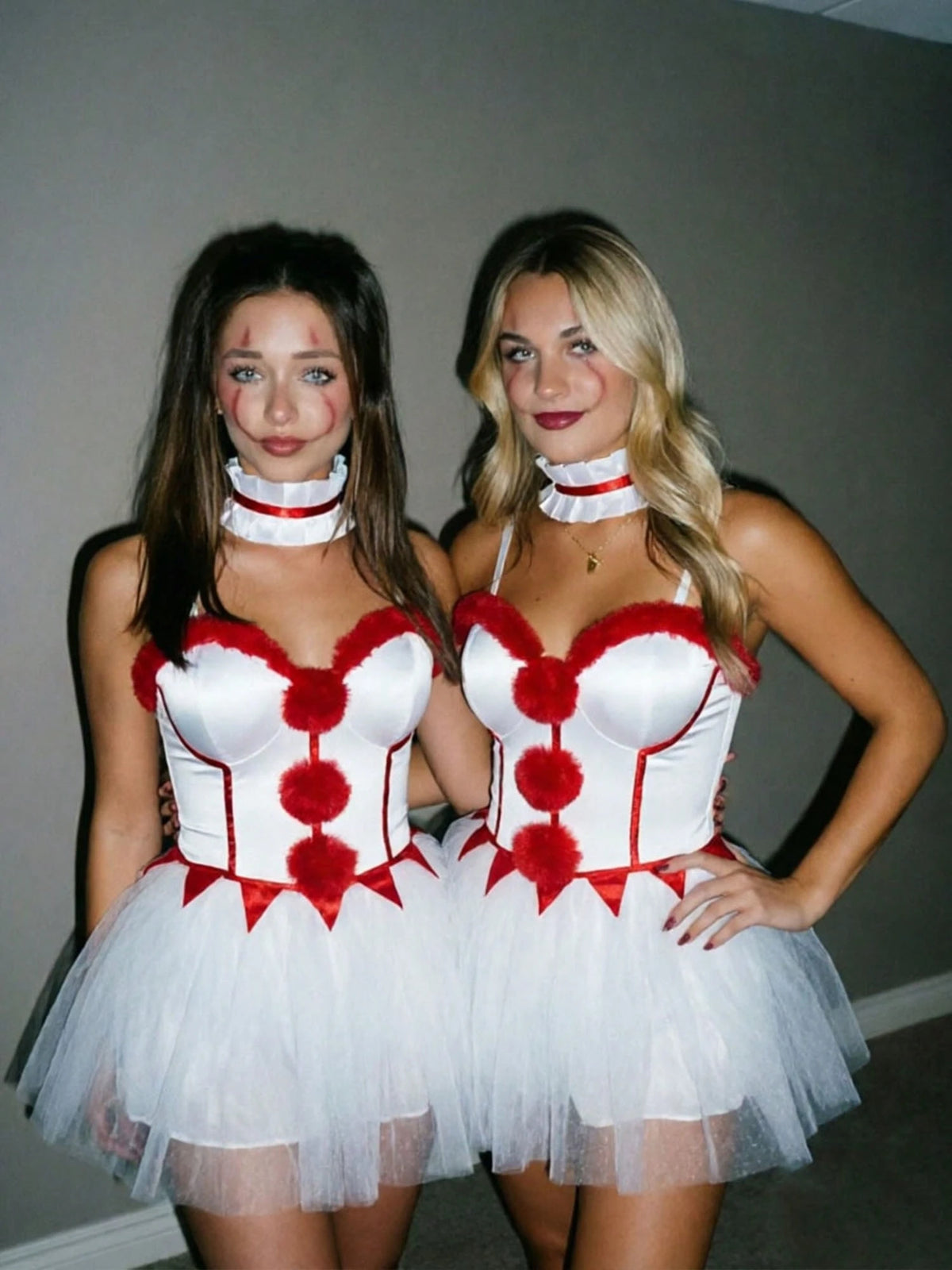 Two models wearing the pom-pom clown costume mini dress