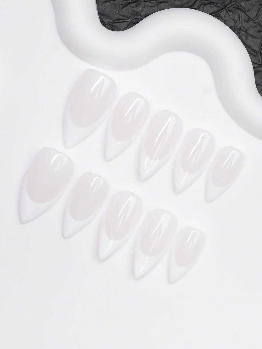 Close view of the white French tips and glossy milky pink almond nails