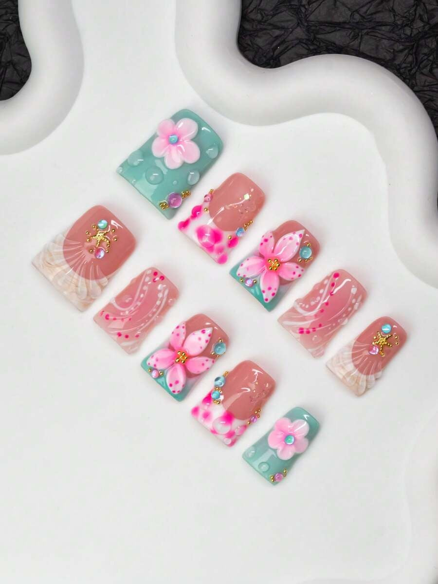 Close view of the tie-dye French tips, shells and crystals on short duck nails
