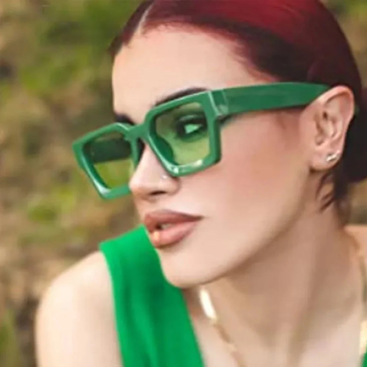 Model outdoors wearing green chunky square sunglasses
