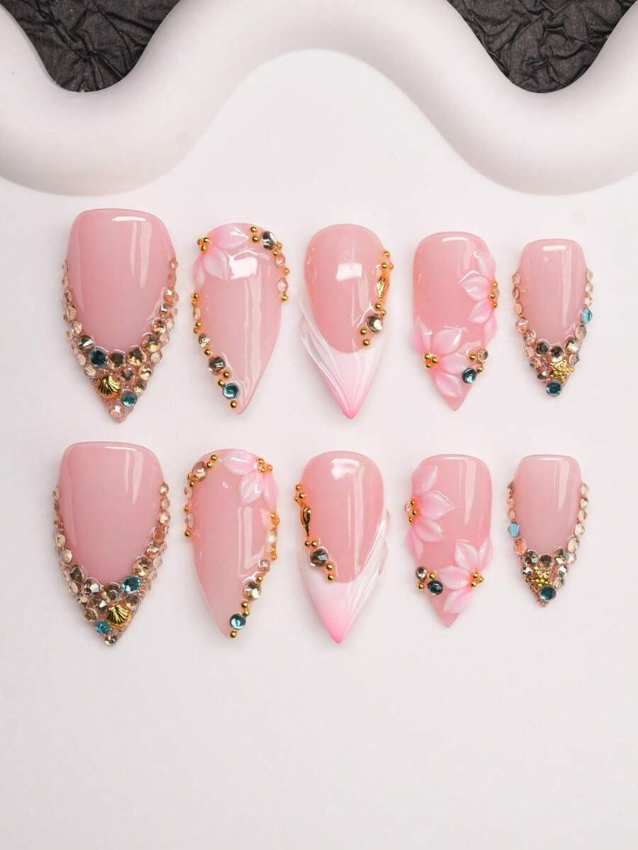 Short almond press-on nails in nude pink French tip with crystals and 3D flowers