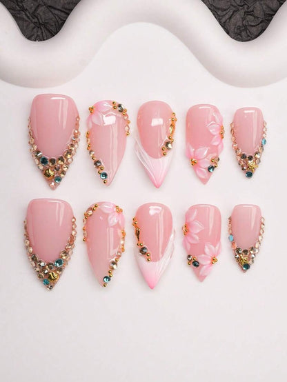 Short almond press-on nails in nude pink French tip with crystals and 3D flowers