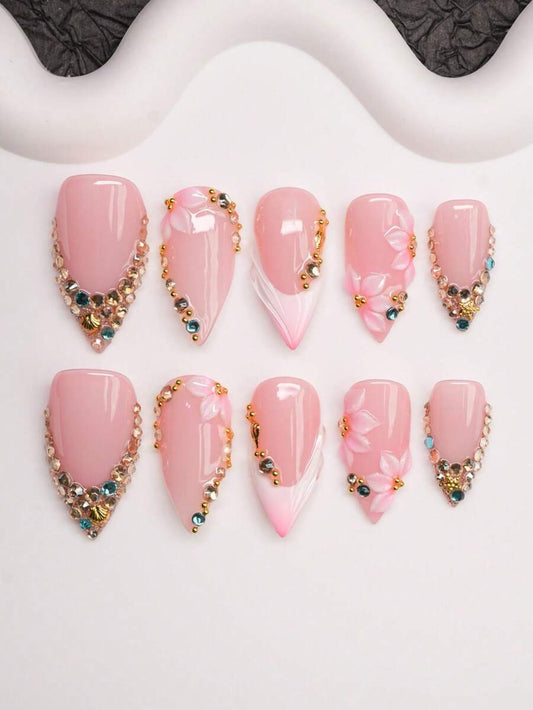 Short almond press-on nails in nude pink French tip with crystals and 3D flowers