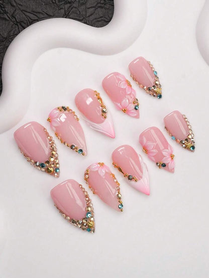 Pink French tip press-on nails with 3D flowers, detail view