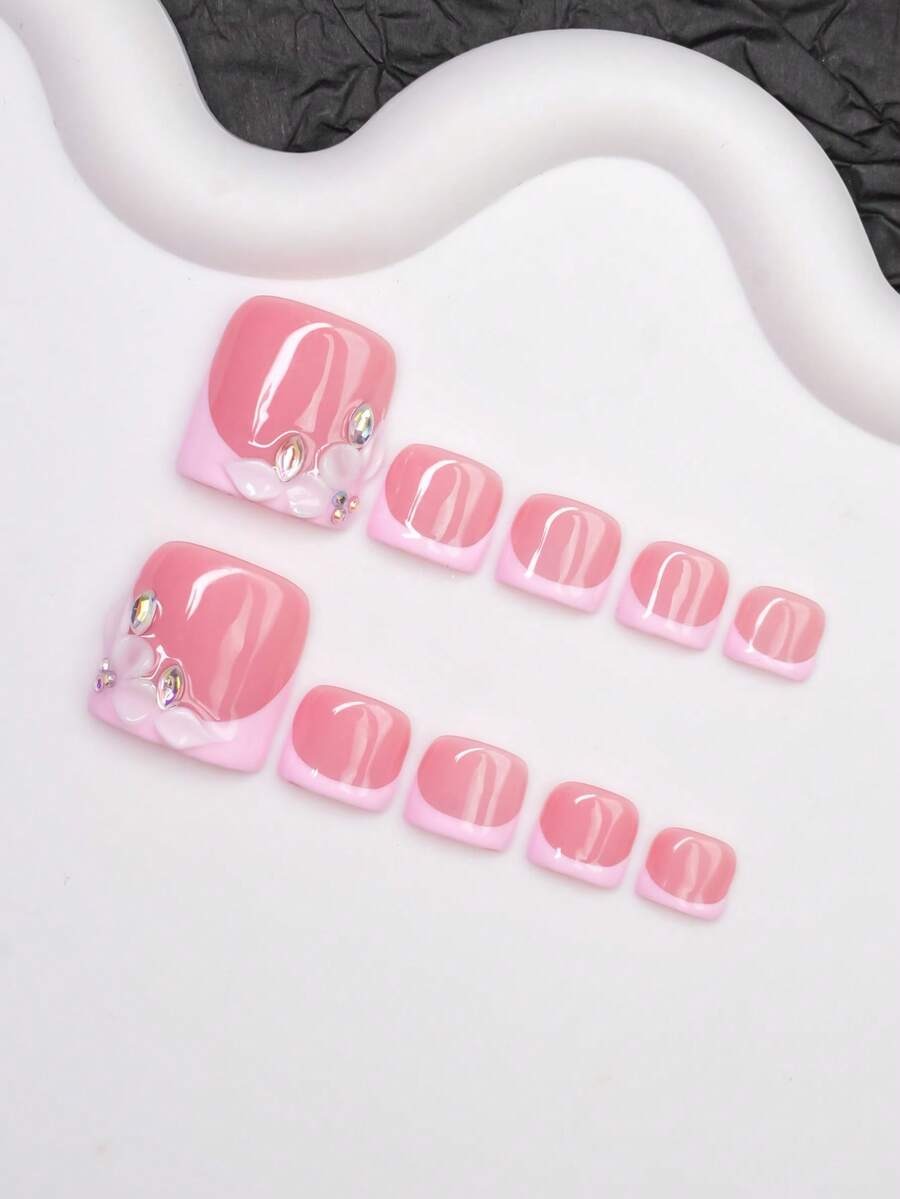 Short square pink press-on toenails with rhinestone flower detail