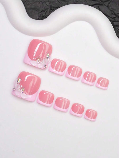 Short square pink press-on toenails with rhinestone flower detail