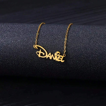 Name necklace draped on a dark surface