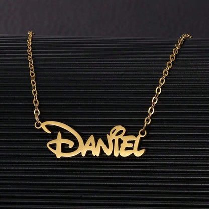 Gold personalized name necklace on a dark background