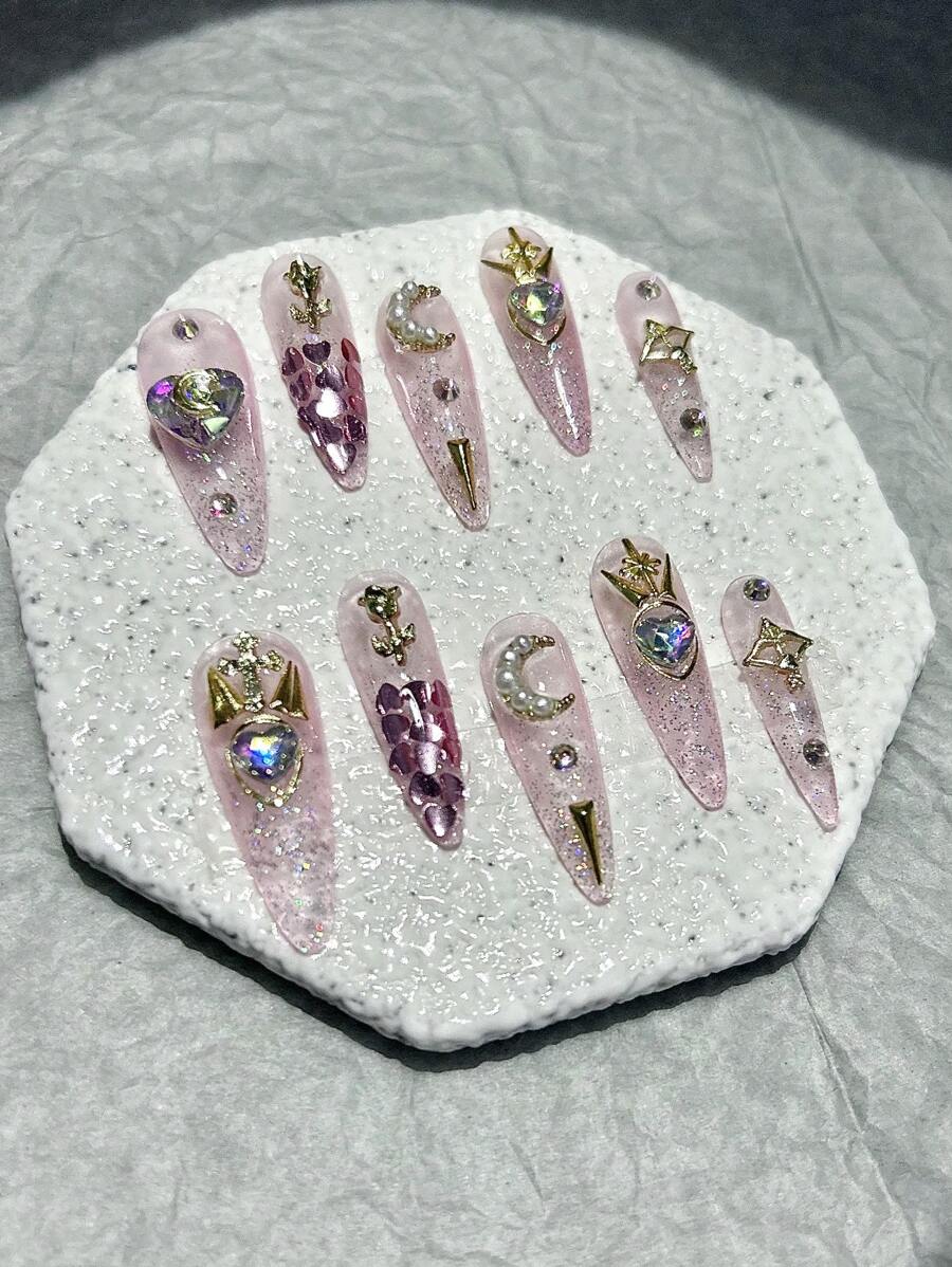 Close detail of the pearl crescent moon and heart gem nails