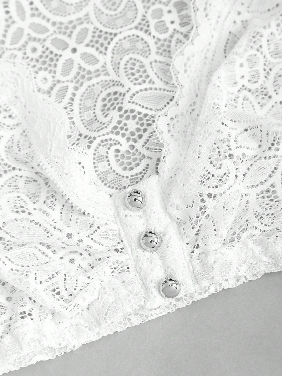 Hand held behind the lace showing the sheer openwork