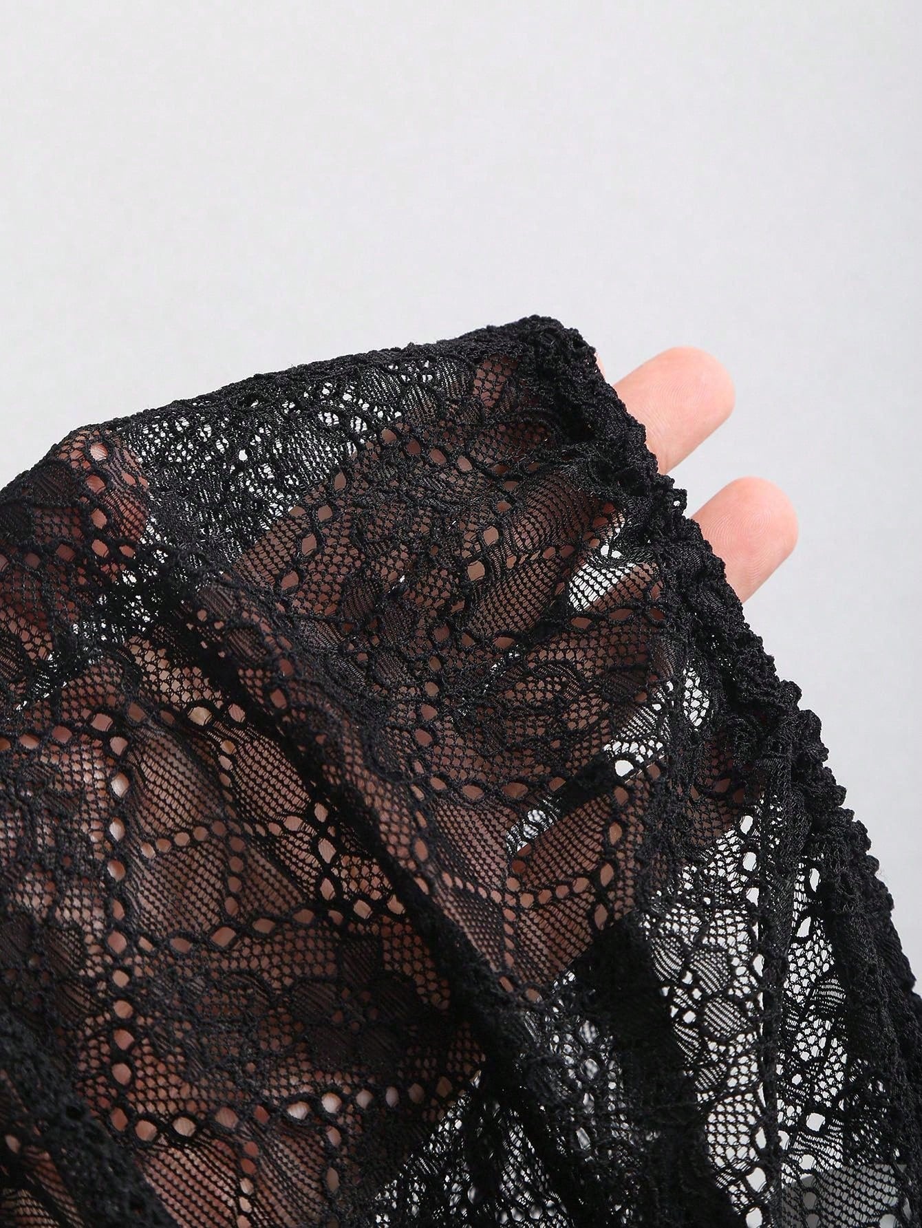 Sheer black lace held to the light