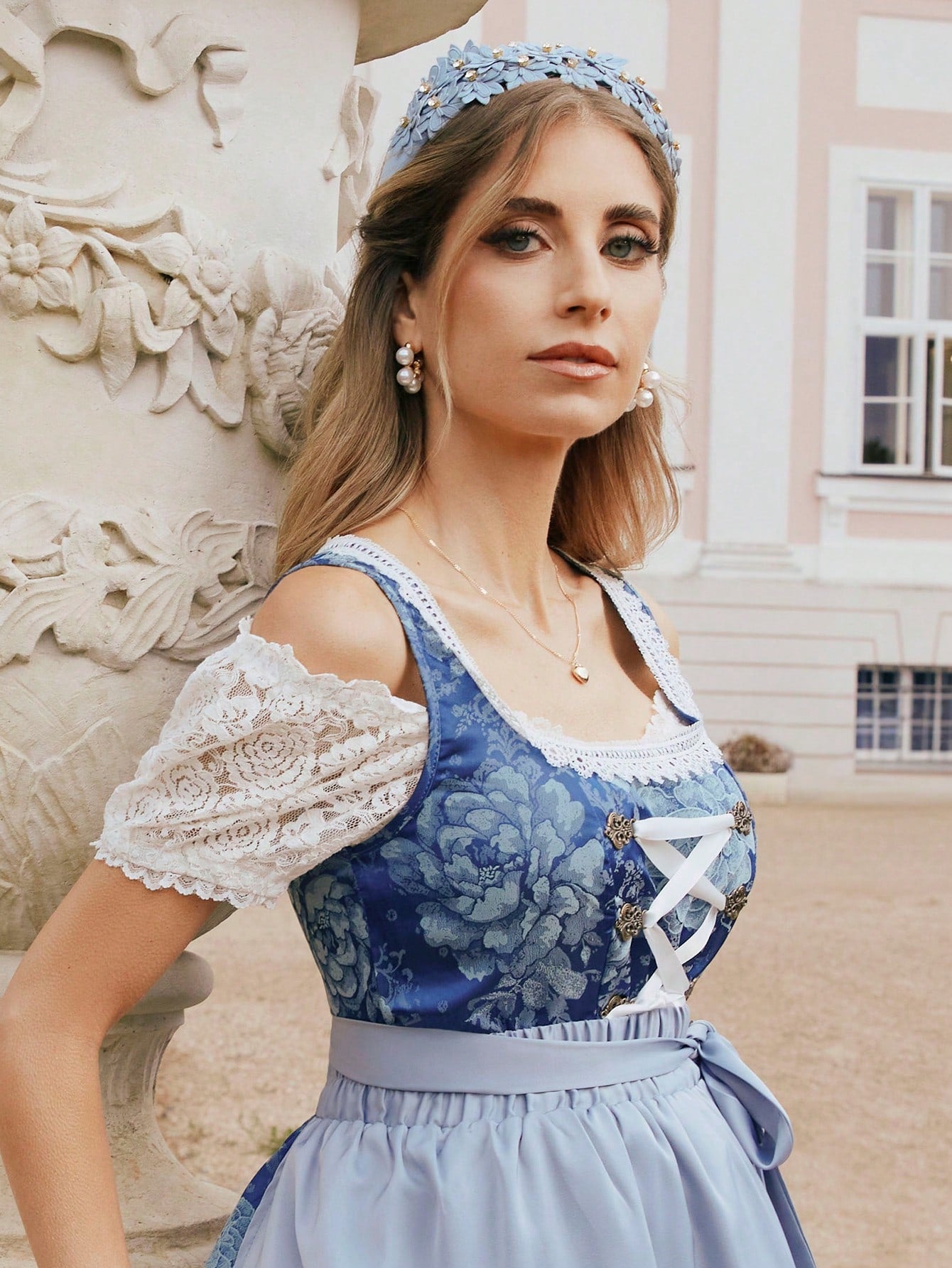 Close view of the lace sleeve and scalloped neckline