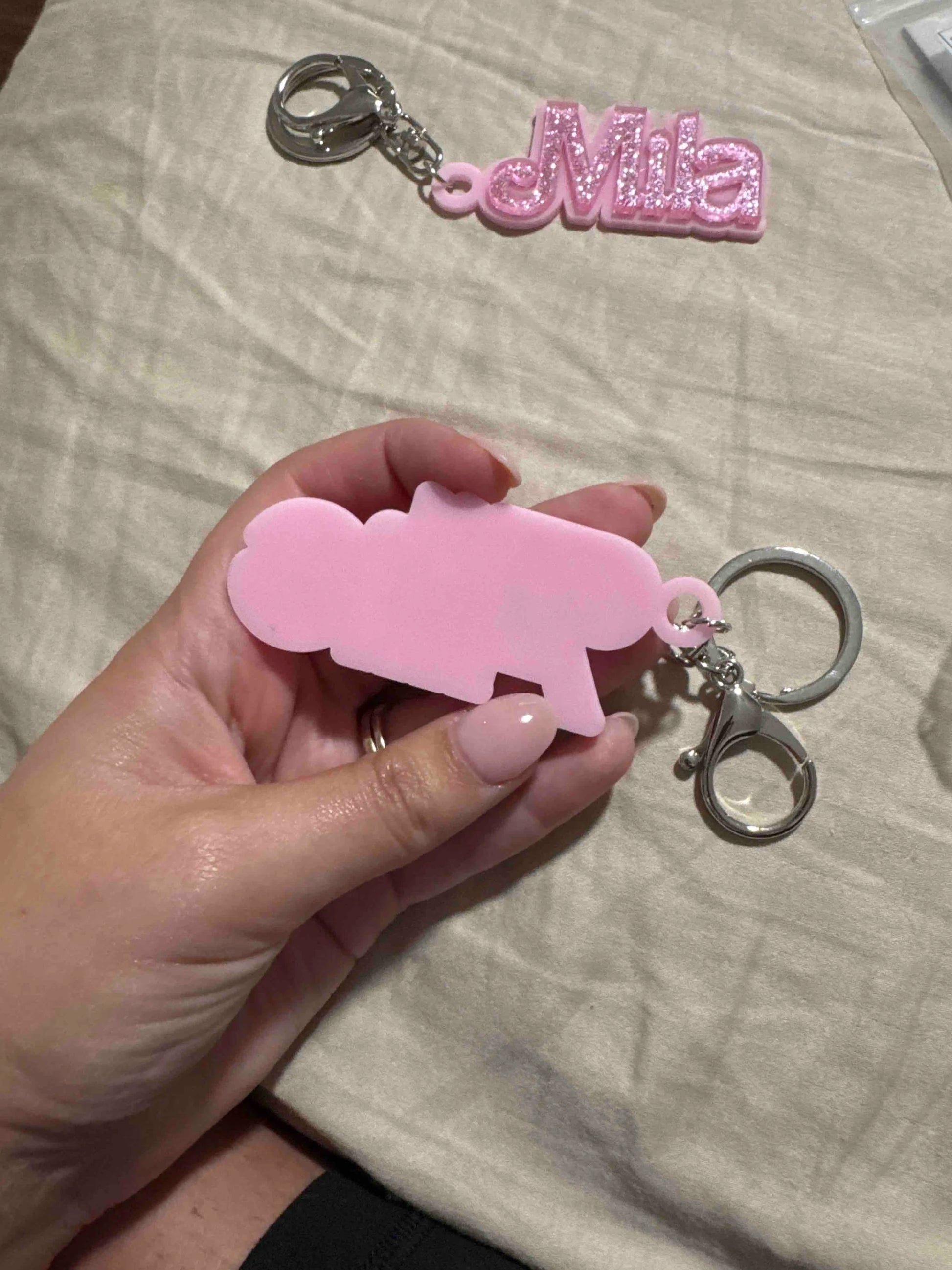 Customer photo - name charm held in hand