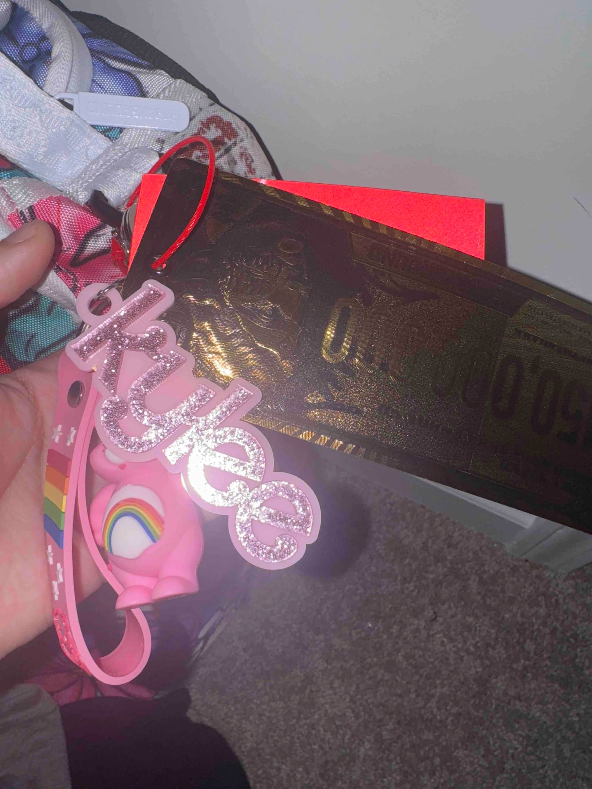 Customer photo - name charm clipped to a bag