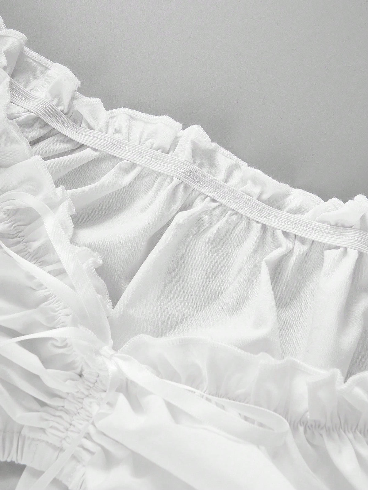 Ruffled neckline and drawstring detail