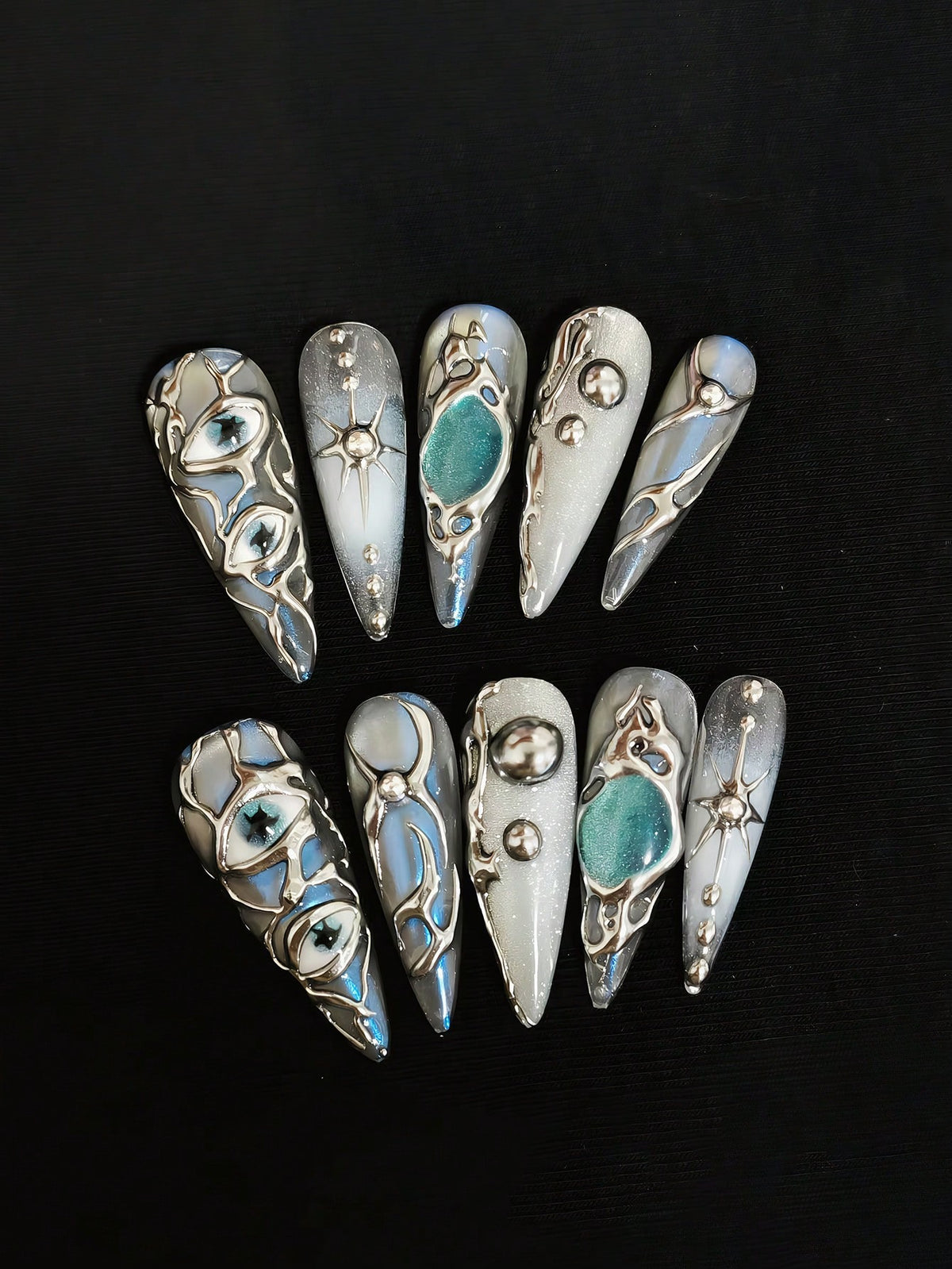 Mercury Gaze long stiletto press on nails in liquid silver chrome with evil eye details