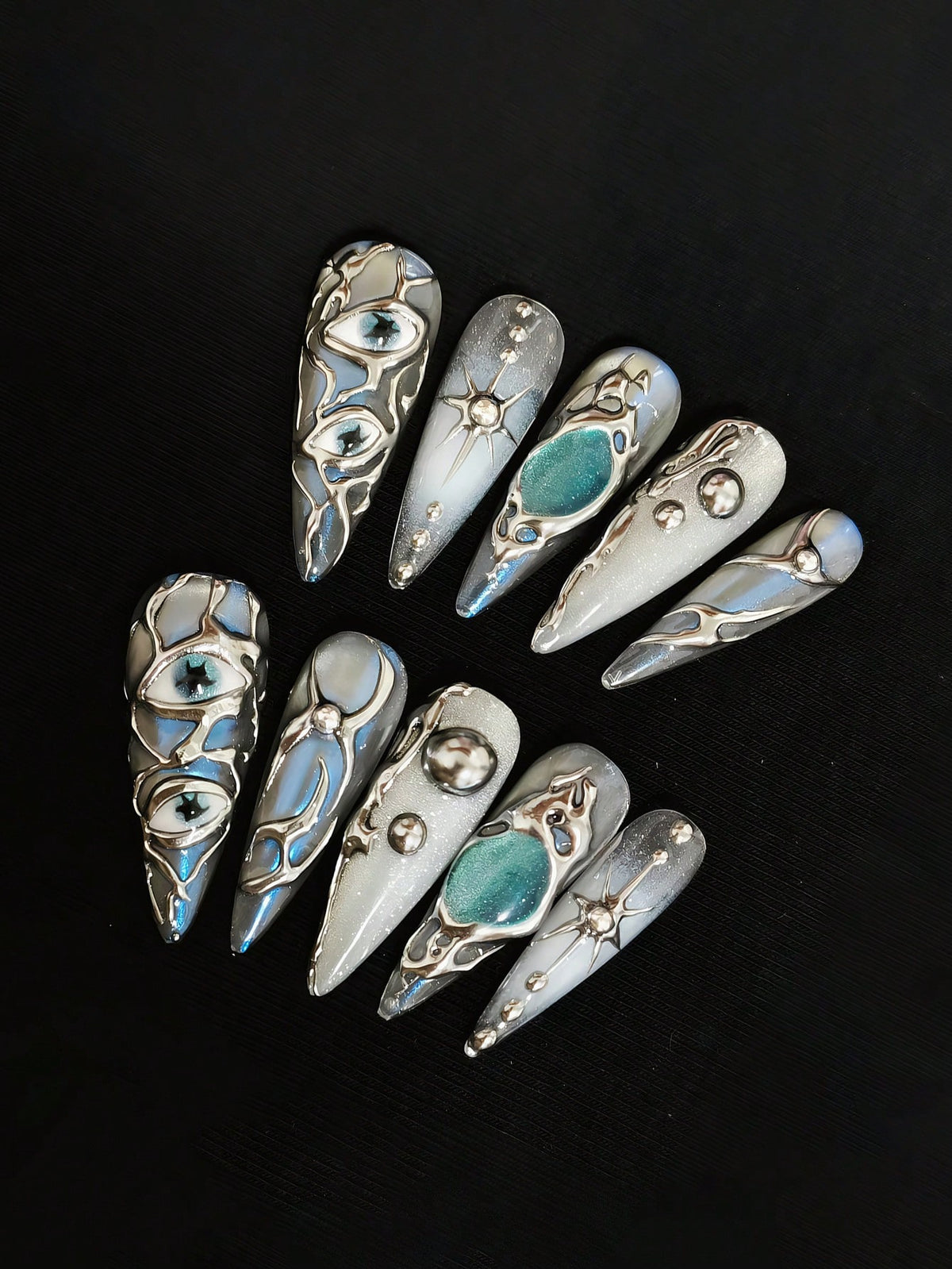 Mercury Gaze press on nails with teal cat-eye stones and star charms