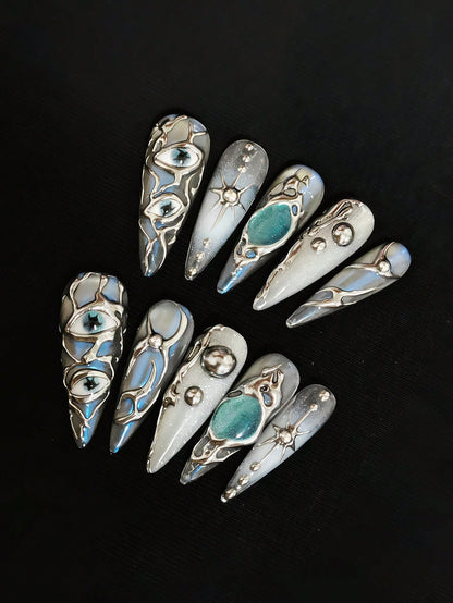 Mercury Gaze press on nails with teal cat-eye stones and star charms