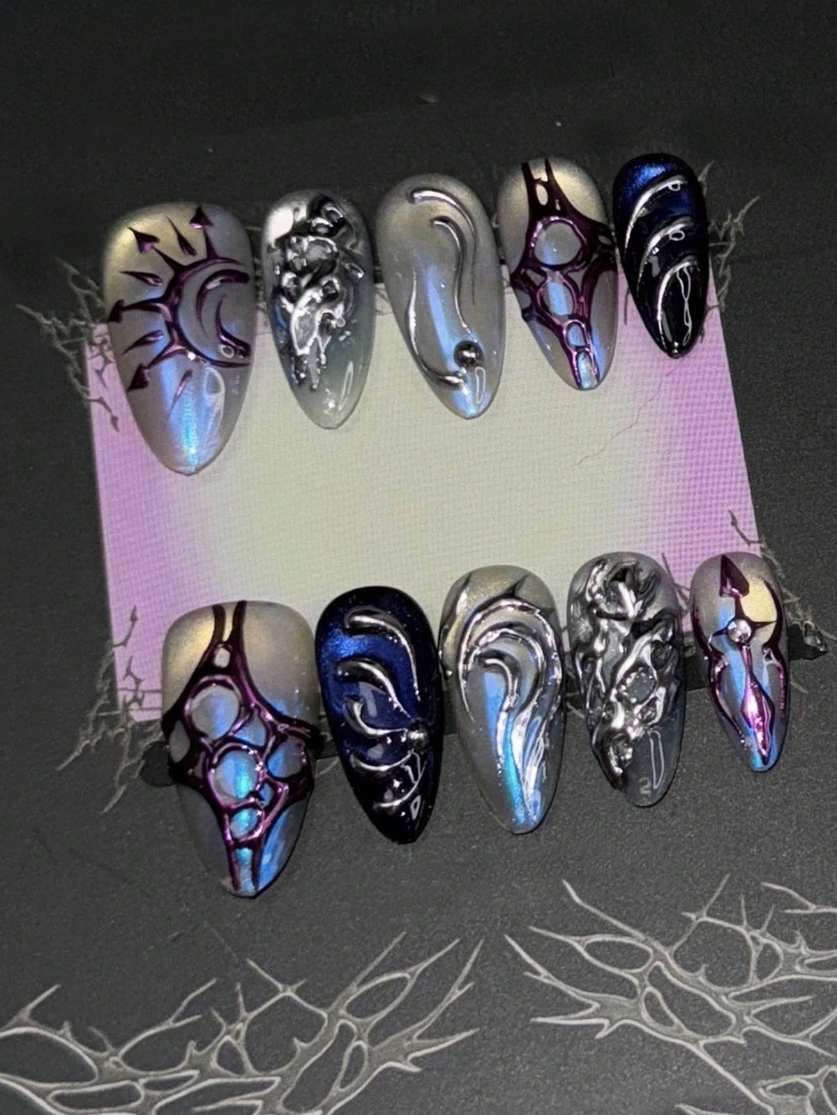 Thornbound Opal almond press on nails in blue chrome with purple thorn webbing