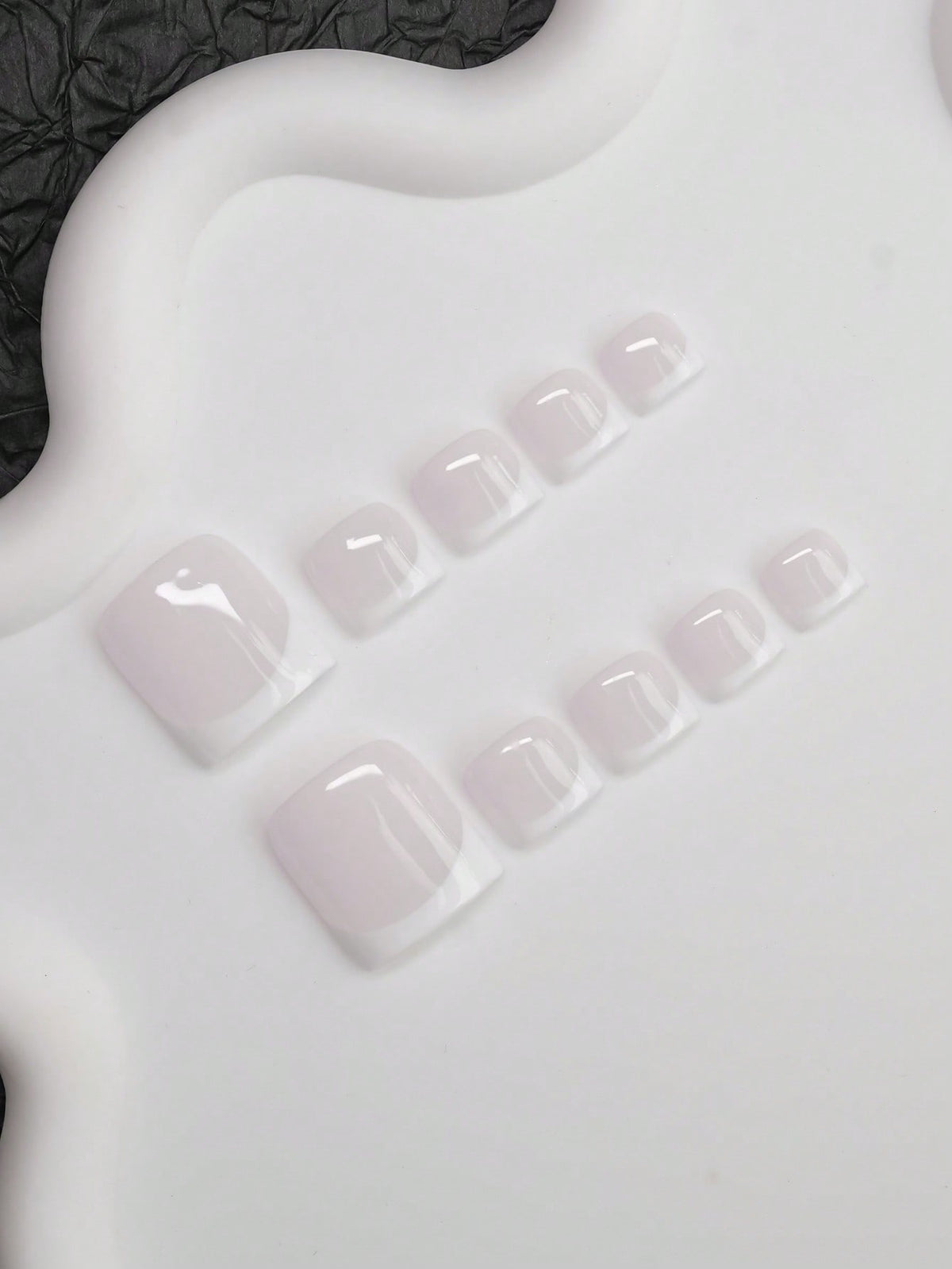 White French press-on toenails, angled view
