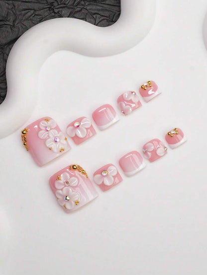 Full set of pink French press-on nails laid out by size