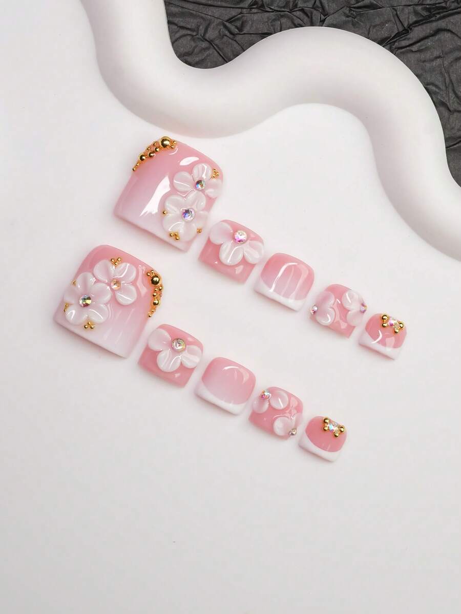 Close view of the 3D floral and crystal detail on the pink French nails