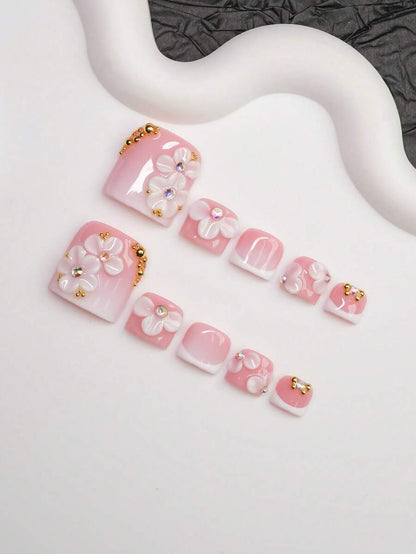 Close view of the 3D floral and crystal detail on the pink French nails