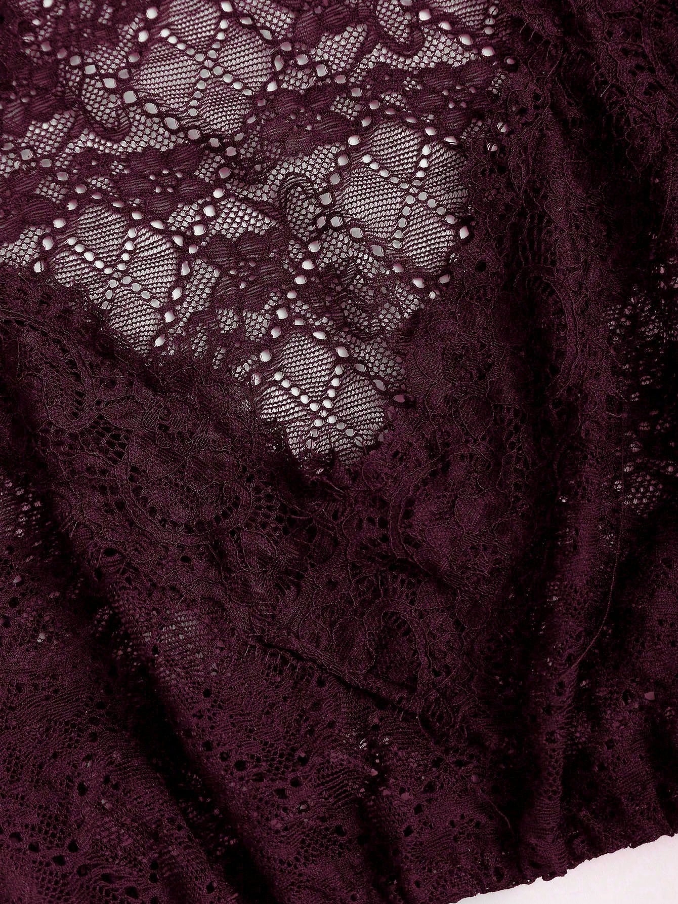 Oxblood baroque lace texture close up