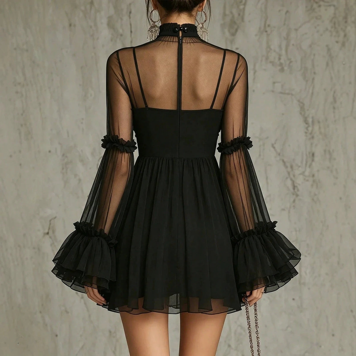 Angled view showing the sheer bell sleeves and ruffled cuffs
