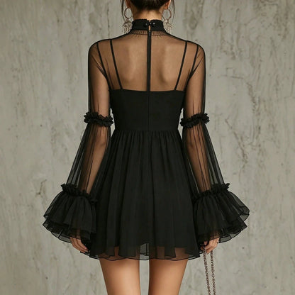 Angled view showing the sheer bell sleeves and ruffled cuffs