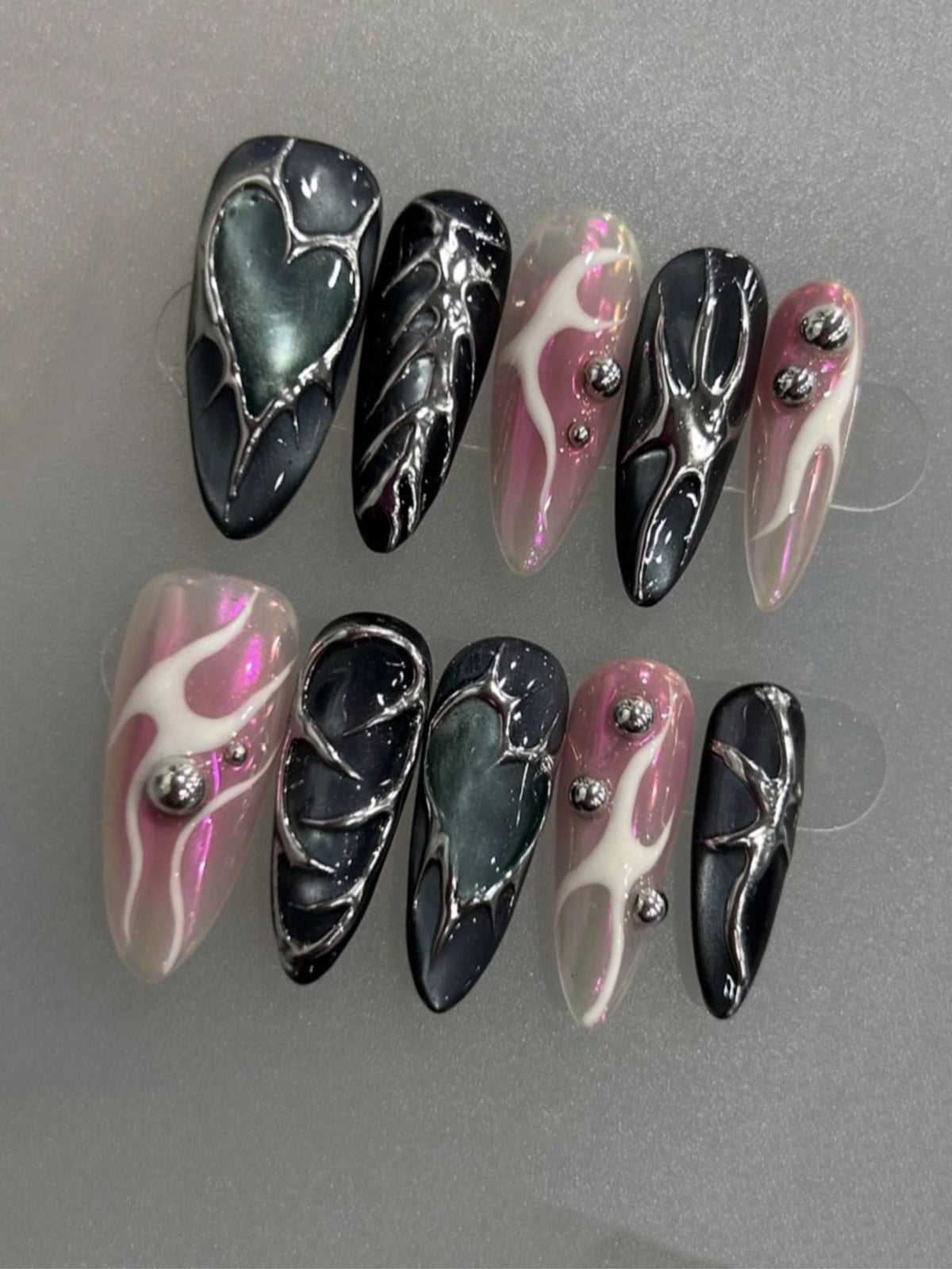 Pink flame and chrome heart almond nails