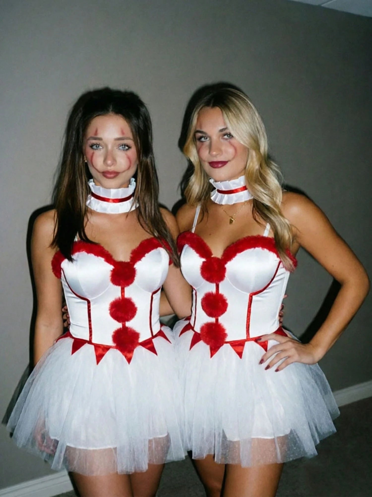 Two models wearing the pom-pom clown costume mini dress