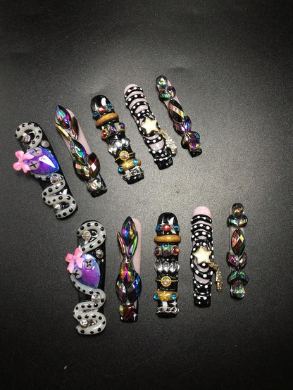 Serpent Siren press-on nails on hand
