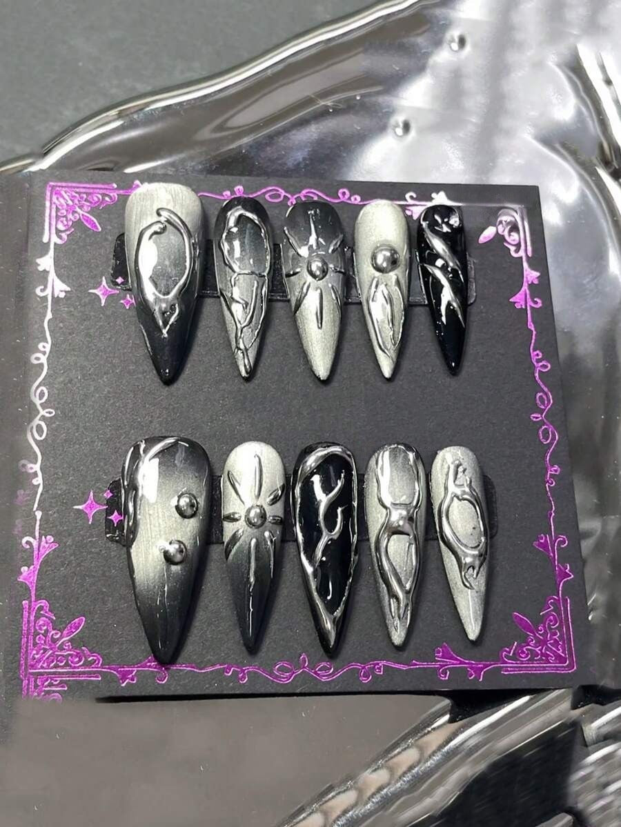Silver cat-eye and black long stiletto press-on nails with raised liquid chrome relief