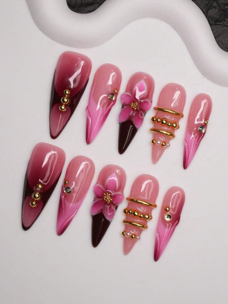 Dark cherry ombre stiletto press-on nails with pink flower and gold ring details