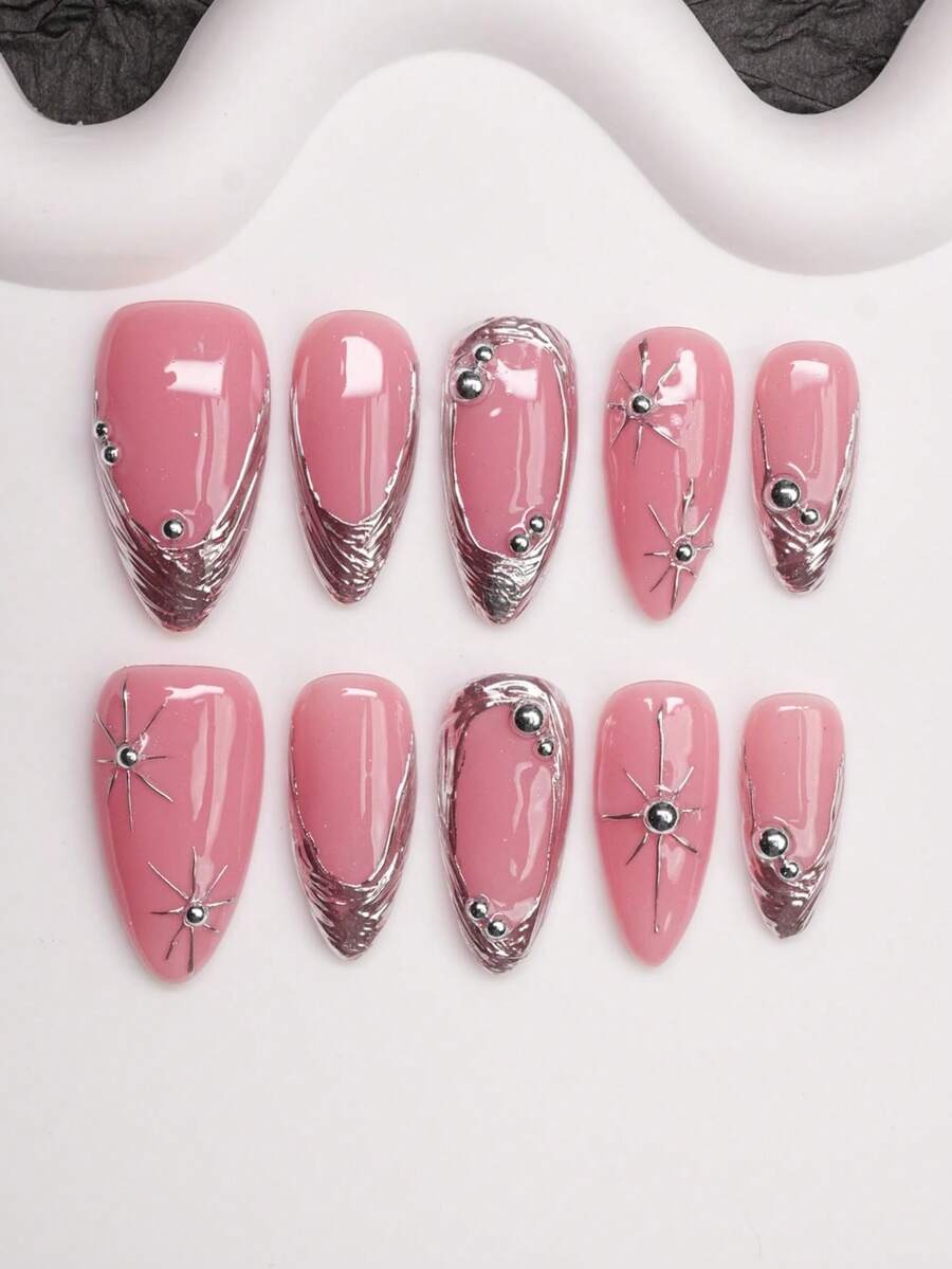 Pink almond press-on nails with chrome silver French tips and silver star charms