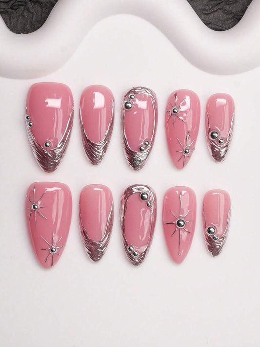Pink almond press-on nails with chrome silver French tips and silver star charms