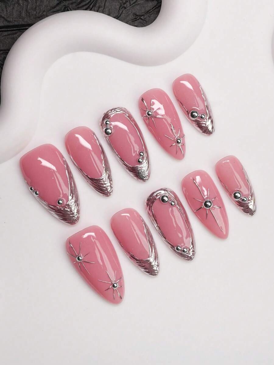 Glossy pink almond press-on nails with chrome tips and beads shown at an angle