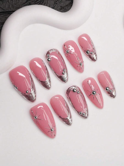 Glossy pink almond press-on nails with chrome tips and beads shown at an angle
