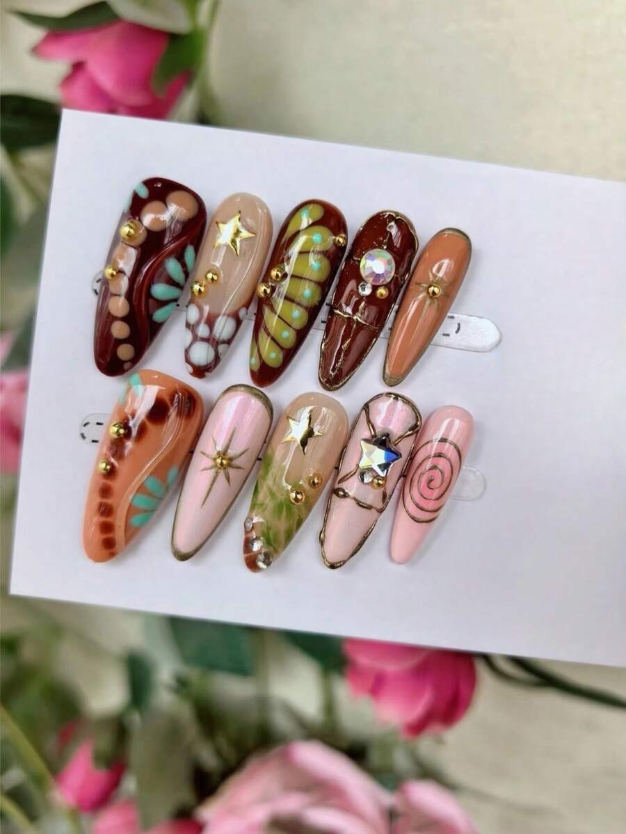 Long almond press-on nails in cocoa, peach and pink with mint dots and gold accents