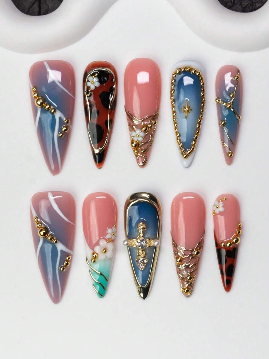 Blue and nude tortoise-shell stiletto press-on nails with gold cross and flowers