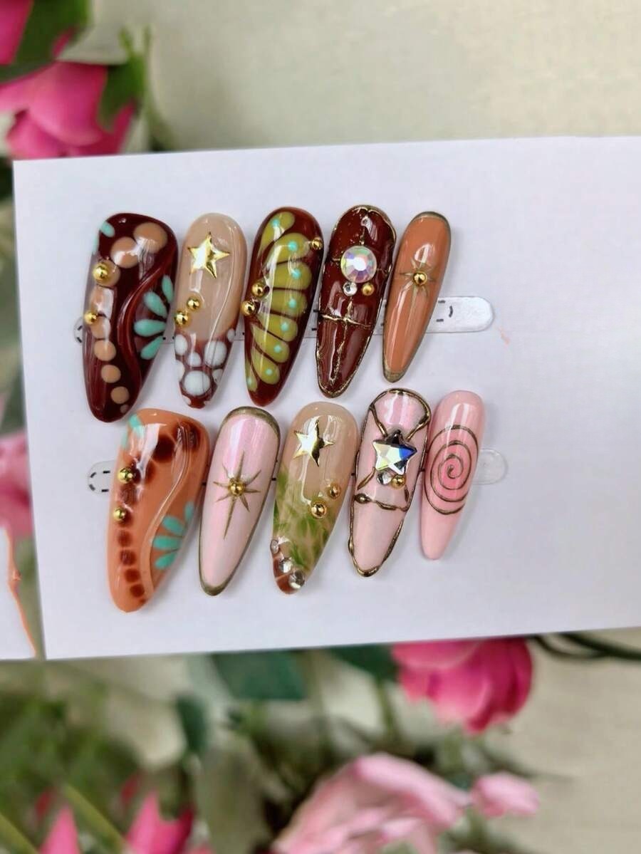 Chocolate, terracotta and peach long almond press-on nails with gold stars and spirals