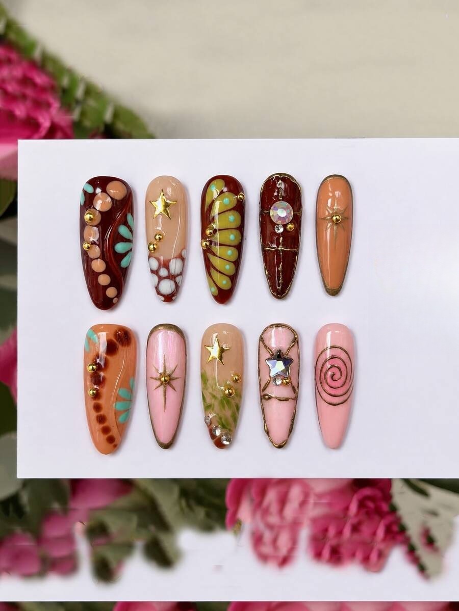Earthy mixed color almond press-on nails with gold lines and a rhinestone star