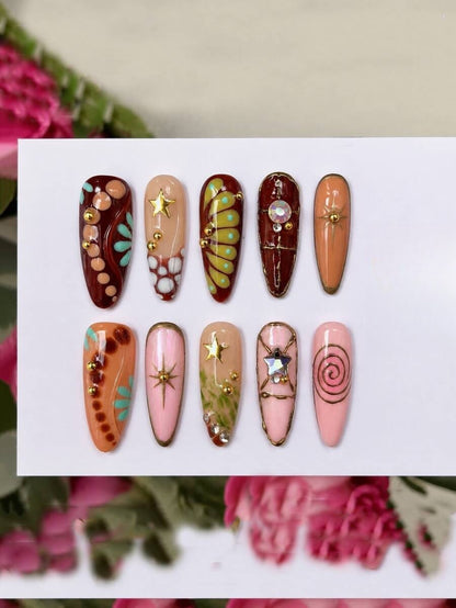 Earthy mixed color almond press-on nails with gold lines and a rhinestone star