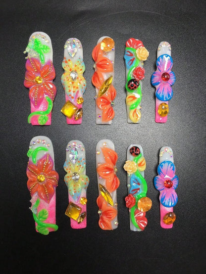 Colorful floral extra long coffin press-on nails on a dark background