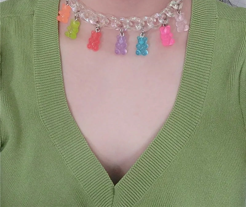 Bear charm chain choker worn with a green cardigan