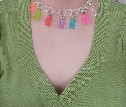 Bear charm chain choker worn with a green cardigan
