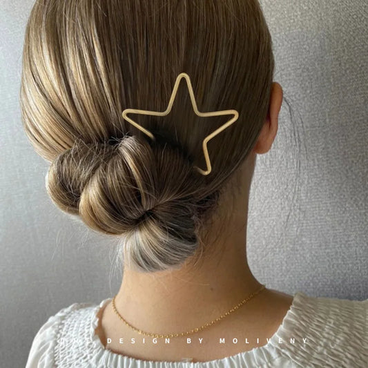 Gold star hair stick worn in a low twisted bun