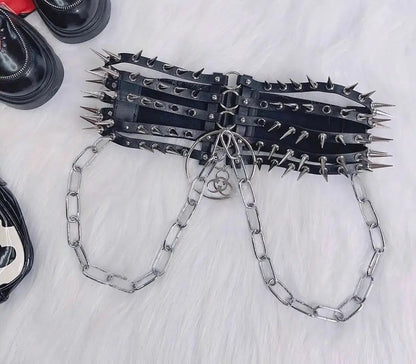 The spiked harness belt laid flat with its chain