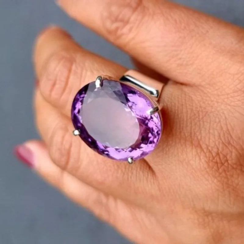 Purple oval ring four prong setting detail